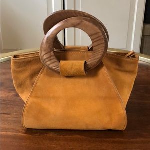 Suede handbag with wood handles